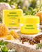 Bergland Bienensalbe 30 ml mit Originalverpackung, dekoriert mit Bienenwachs, Honigwabe, Propolis und frischen Blüten auf hellem Naturstein.