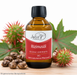 Jophiel Aromaöle Bio Rizinusöl in einer braunen Glasflasche mit schwarzem Schraubverschluss, dekoriert mit Rizinussamen, grünen Blättern und Rizinusfrüchten auf einer hellen Holzoberfläche.