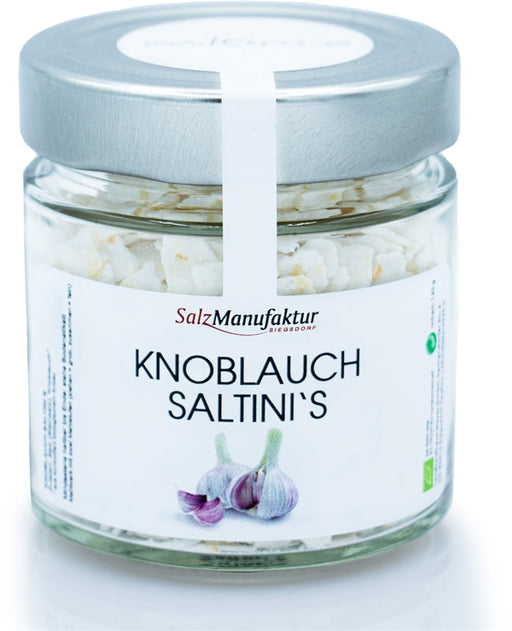 SalzManufaktur Siegsdorf Knoblauch Saltini's im Glas mit silbernem Deckel, freigestellt auf weißem Hintergrund.